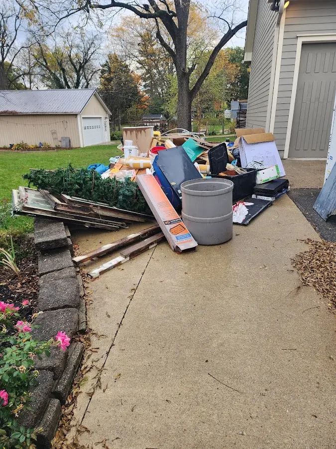 Dumpster being loaded with debris for 12 Yard Dumpster Rental in Williston